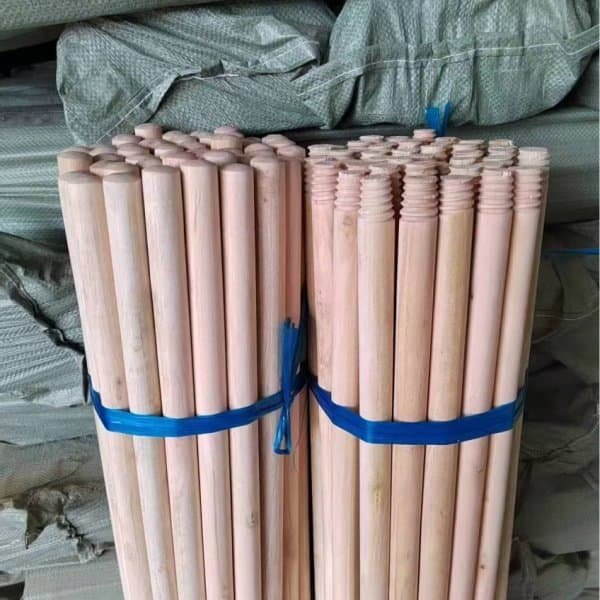 Neatly stacked bundles of finished wooden broom stick products