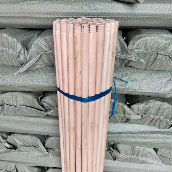 High-quality finished wooden broom stick stacked in bundles