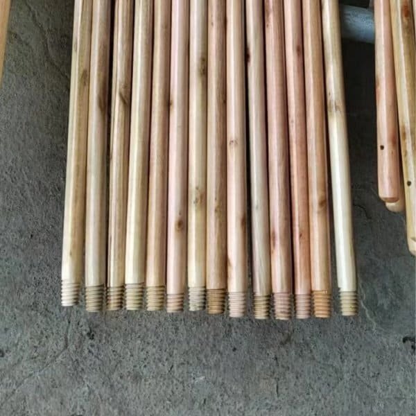 Neatly arranged varnished wooden broom sticks with italian threaded ends, customized handle equipped garden broom factory products