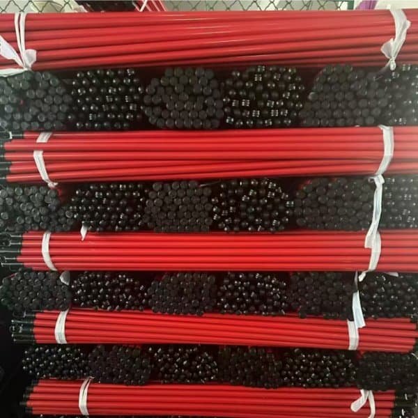 Bulk stacked red coated hollow iron broom sticks from reliable wholesale iron stick red broom suppliers