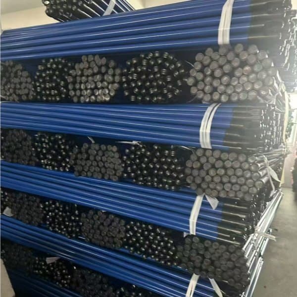 Warehouse-stacked blue color iron broom sticks with black caps, from trusted wholesale iron stick red broom suppliers for bulk cleaning supply orders.