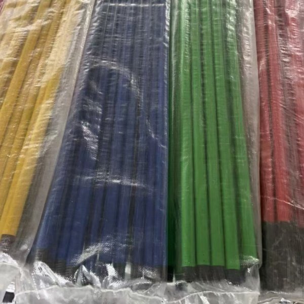Multi-color iron broom sticks (yellow, blue, green, red) in clear plastic wrap, from professional wholesale iron stick red broom suppliers for bulk cleaning supply orders.