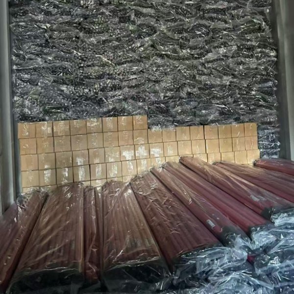 Fully loaded shipping container with bulk-wrapped red iron broom sticks from trusted wholesale iron stick red broom suppliers, ready for worldwide delivery.