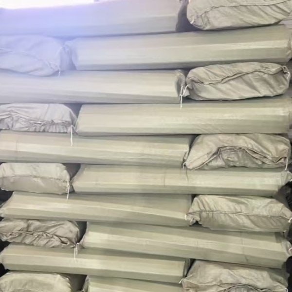 Large quantities of plastic broom handles securely packed for export, supplied by a reliable customized plastic long handled sweeping broom factory