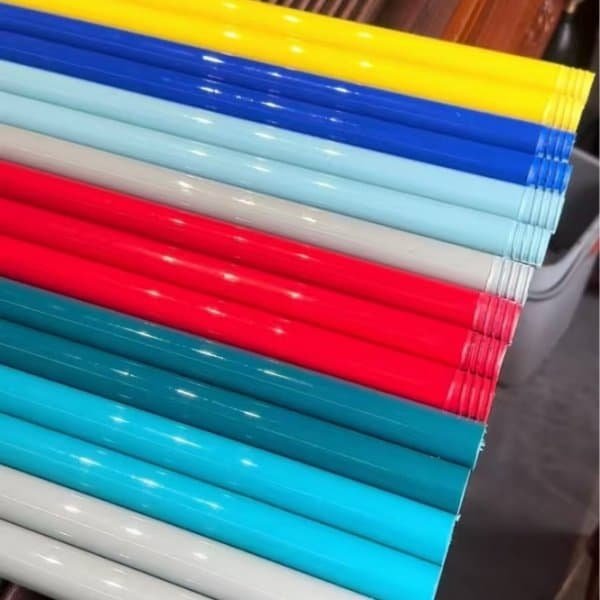 Assorted vibrant plastic broom handles from a customized plastic long handled sweeping broom factory