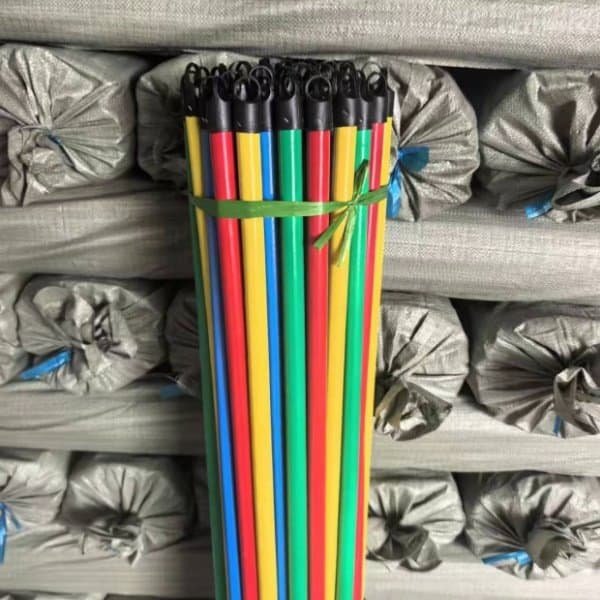 Wood broom handles in red, yellow, blue and green colors
