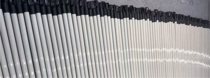 Neatly arranged different types of broom stick with black plastic heads for cleaning supplies