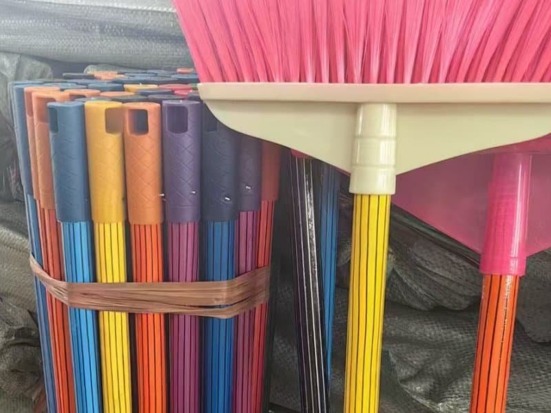 Colorful different types of broom stick matched with broom heads for household cleaning tools