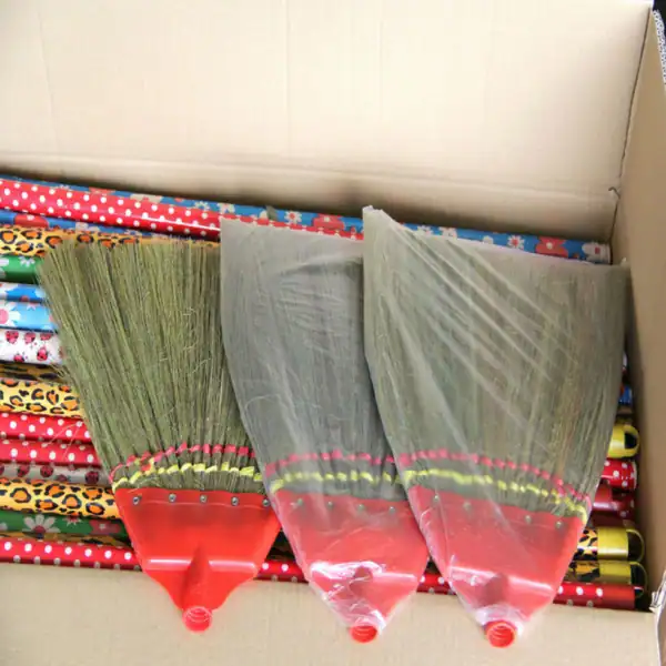 Broom grass suppliers in india source high-quality natural grass brooms from China factory with colorful pvc coated wooden handles