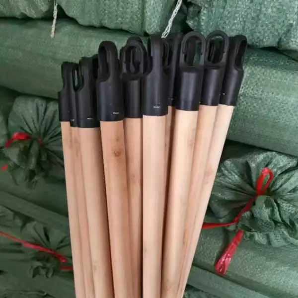 Natural wooden broom stick manufacturers provide high-quality polished natural wooden broom handles with durable 7 cm black plastic hanging caps for bulk export