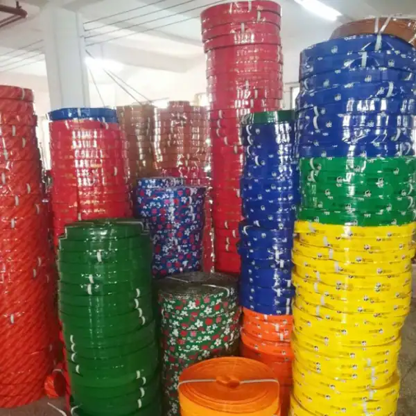 Warehouse stacked bulk rolls of various pvc film types for pvc coated broom sticks, solid color and floral printed PVC coating films in factory stock for broom handle OEM wholesale