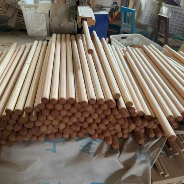 Smooth finished beech wood dowels stacked in workshop from beech wood handle manufacturers for custom wooden handle CNC production