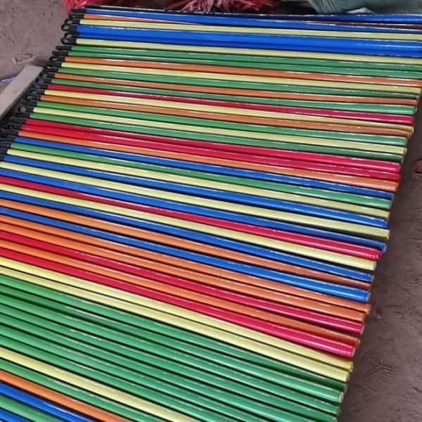 PVC Coated Wooden Broom Handle Suppliers, moisture resistant ribbed pvc wooden broom handles neatly laid out in factory workshop