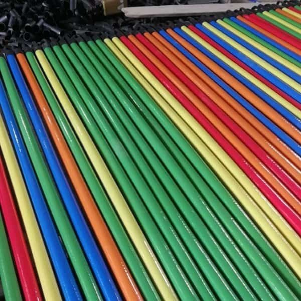Ribbed PVC Coated Wooden Broom Stick Suppliers, factory stacked colorful ribbed wooden broom sticks for wholesale importers